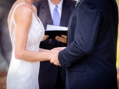 Couple holding hands during an outdoor wedding ceremony at Pine Creek Place on Johns Island, South Carolina